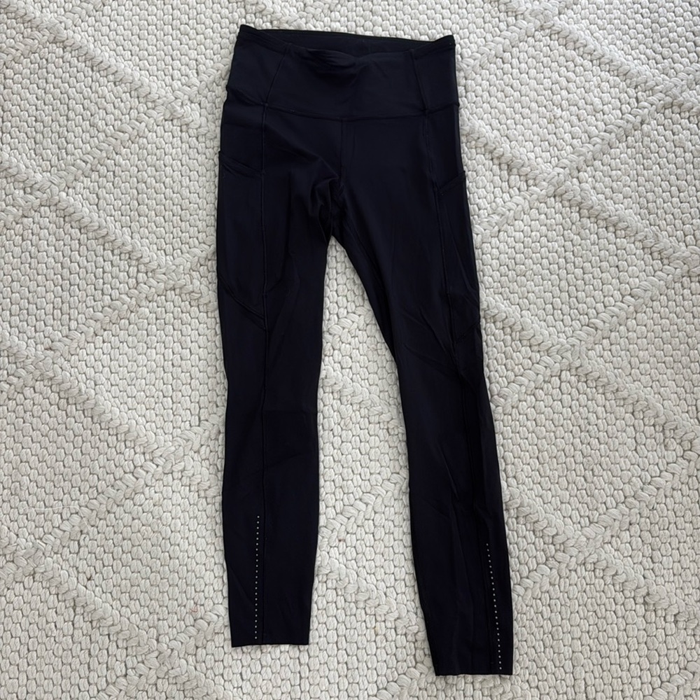 Black Lululemon leggings with reflective dots